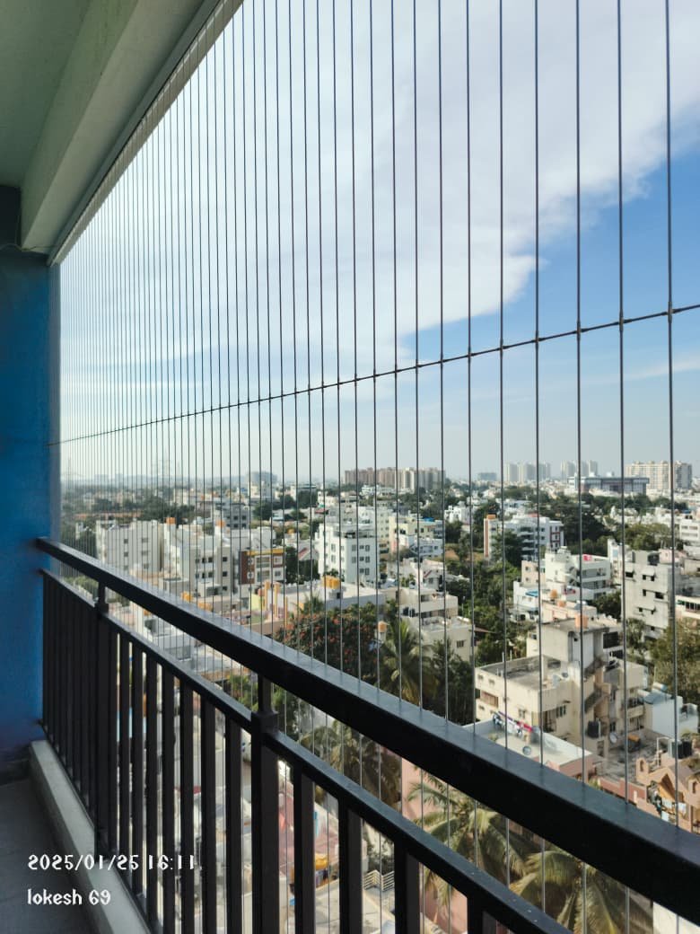 Child-safe invisible grills installed on a high-rise apartment balcony